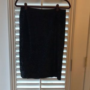 A deep navy blue almost black sequin pencil skirt